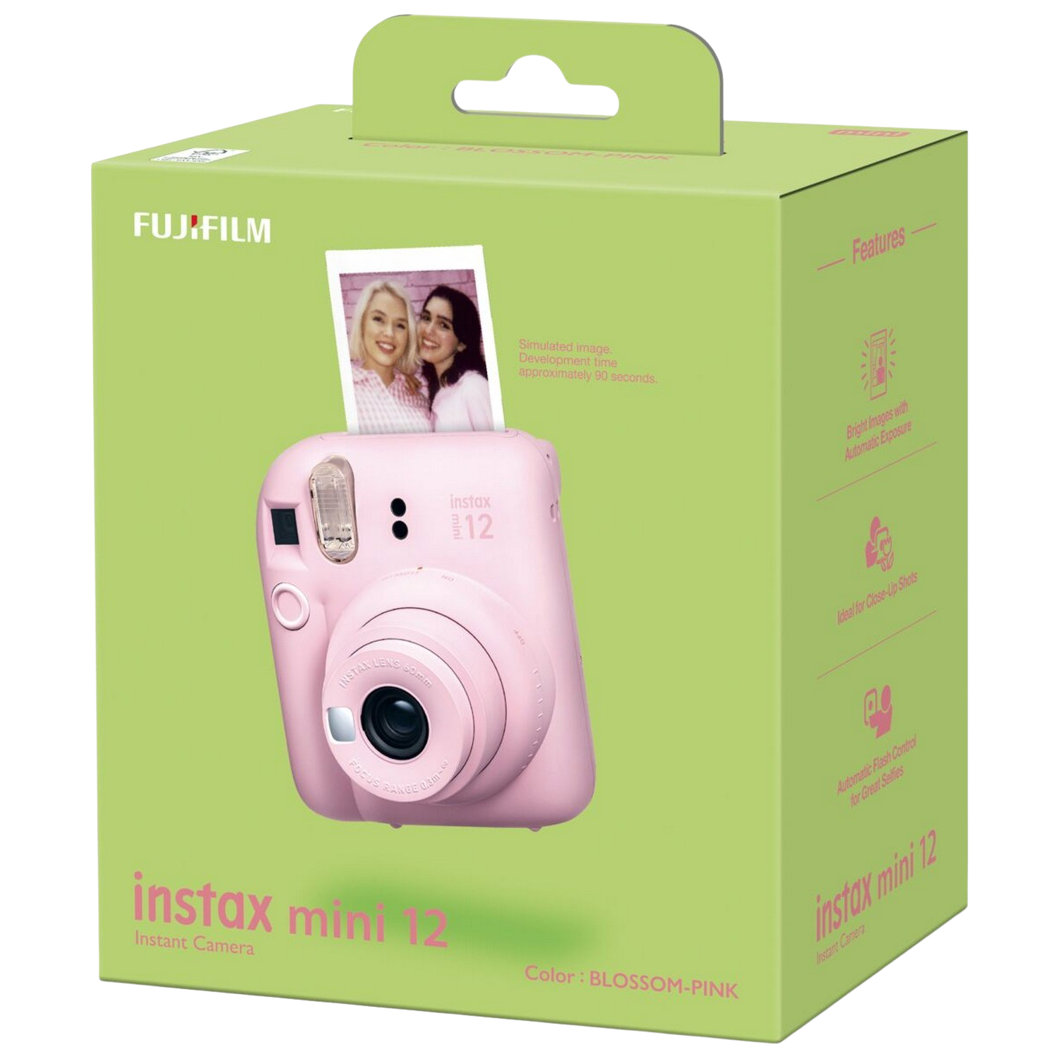 Roze instant camera in een groene doos, met afgedrukte foto. Witte achtergrond.