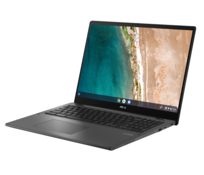 Ein dunkelgrauer Laptop auf einer weißen Oberfläche, der Bildschirm zeigt eine Strandszene.