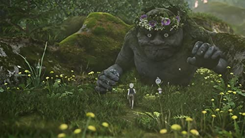 Una escena de juego con una criatura de piedra gigante en el fondo. Una persona pequeña camina por un camino.