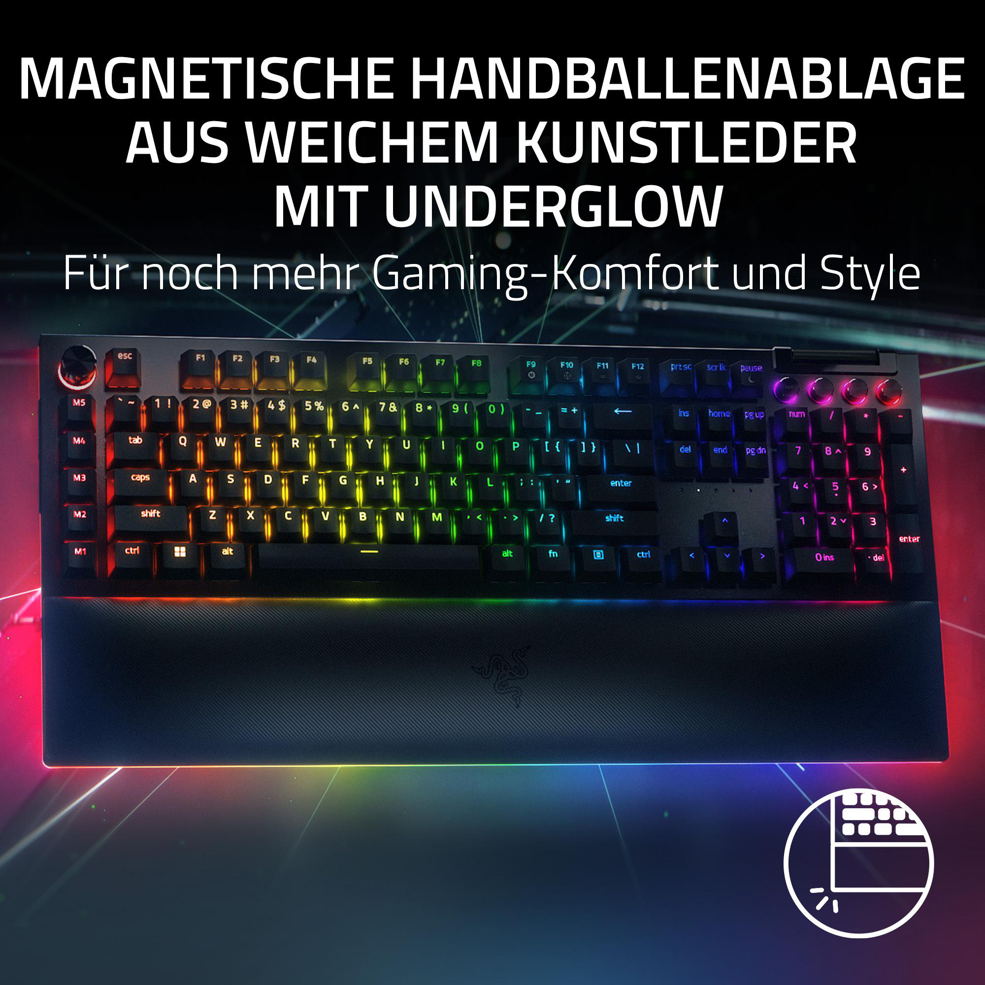 Schwarze Tastatur mit bunten Tasten und Handballenauflage, leuchtend.