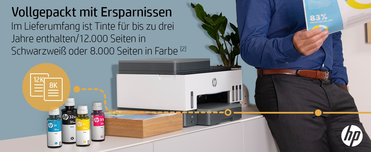 Eine Person mit einem Drucker und Tintenflaschen auf einem Schreibtisch.