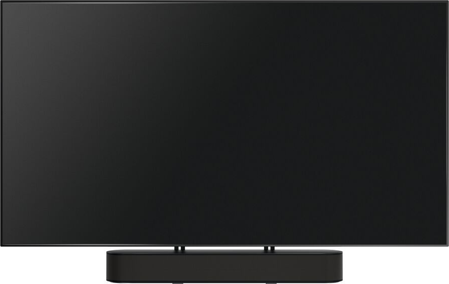 Une grande télévision noire avec une barre de son noire à la base, sur une surface blanche.