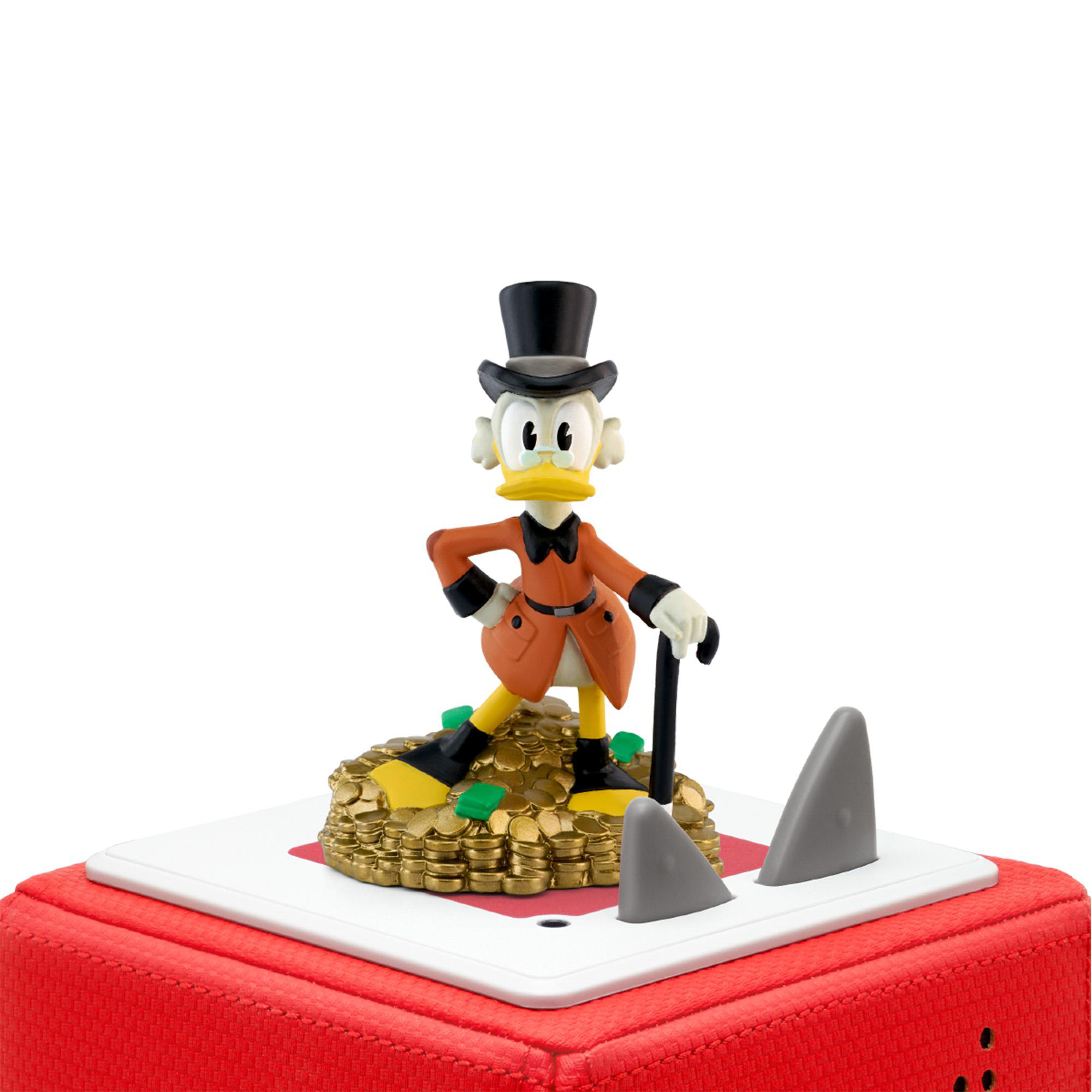 Dagobert Duck Figur auf einem Goldmünzenhaufen. Haifischflossen umgeben eine rote Basis.