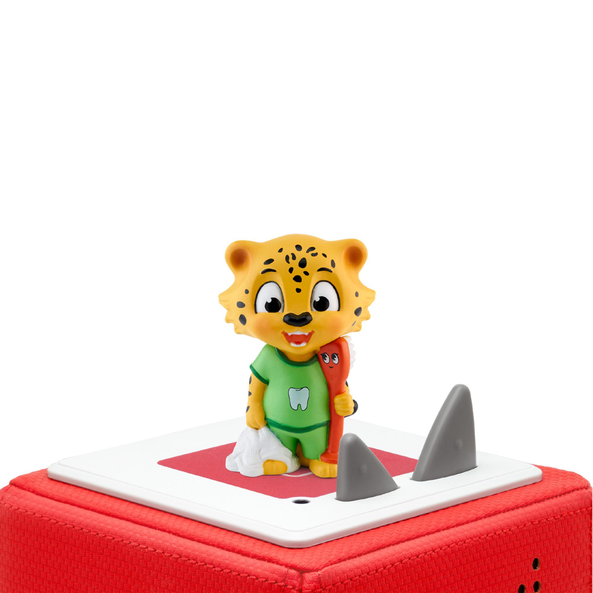 Cartoon Jaguar-Spielzeug, das eine Zahnbürste und eine kleine Tasche hält. Es steht auf einer rot-weißen Plattform.