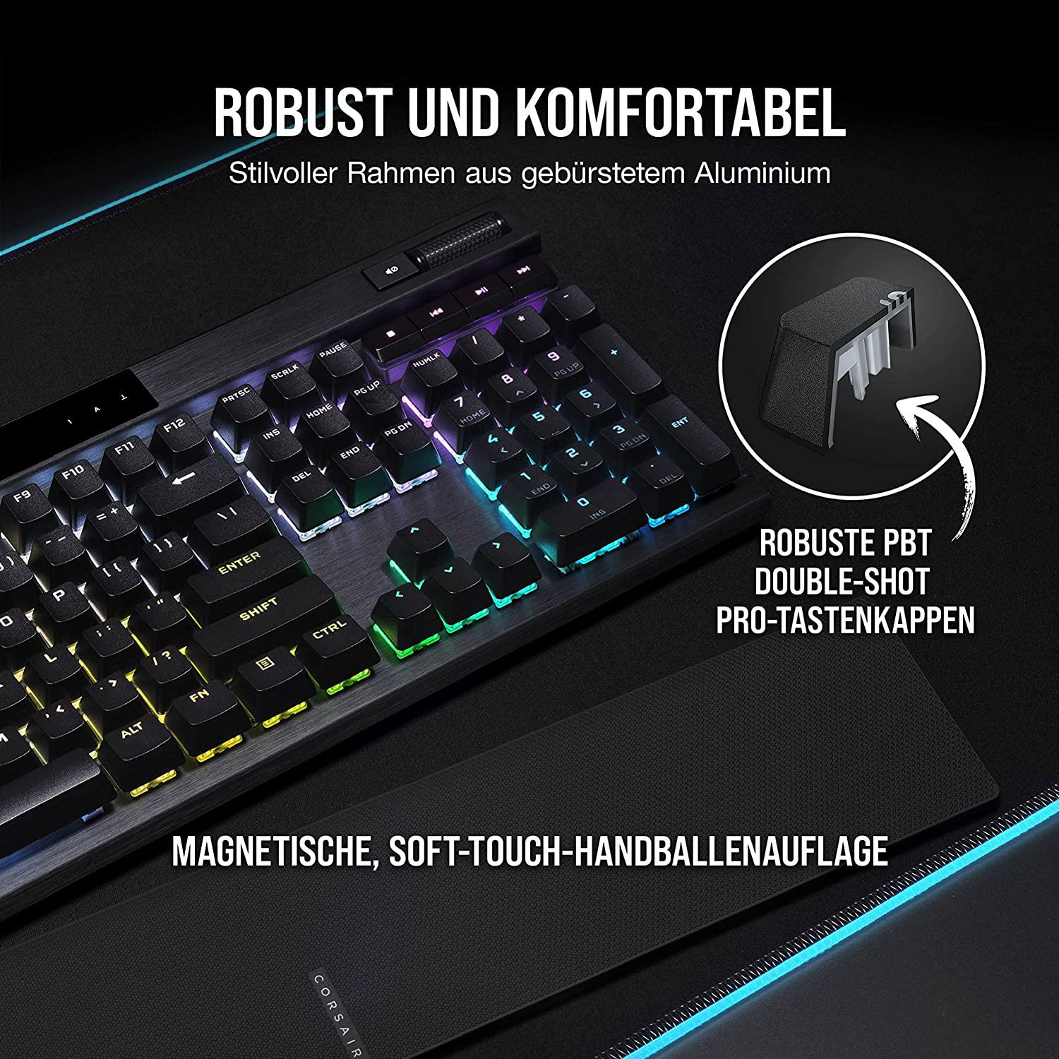 Eine schwarze Tastatur mit bunten Tasten und Handballenauflage auf dunklem Hintergrund.