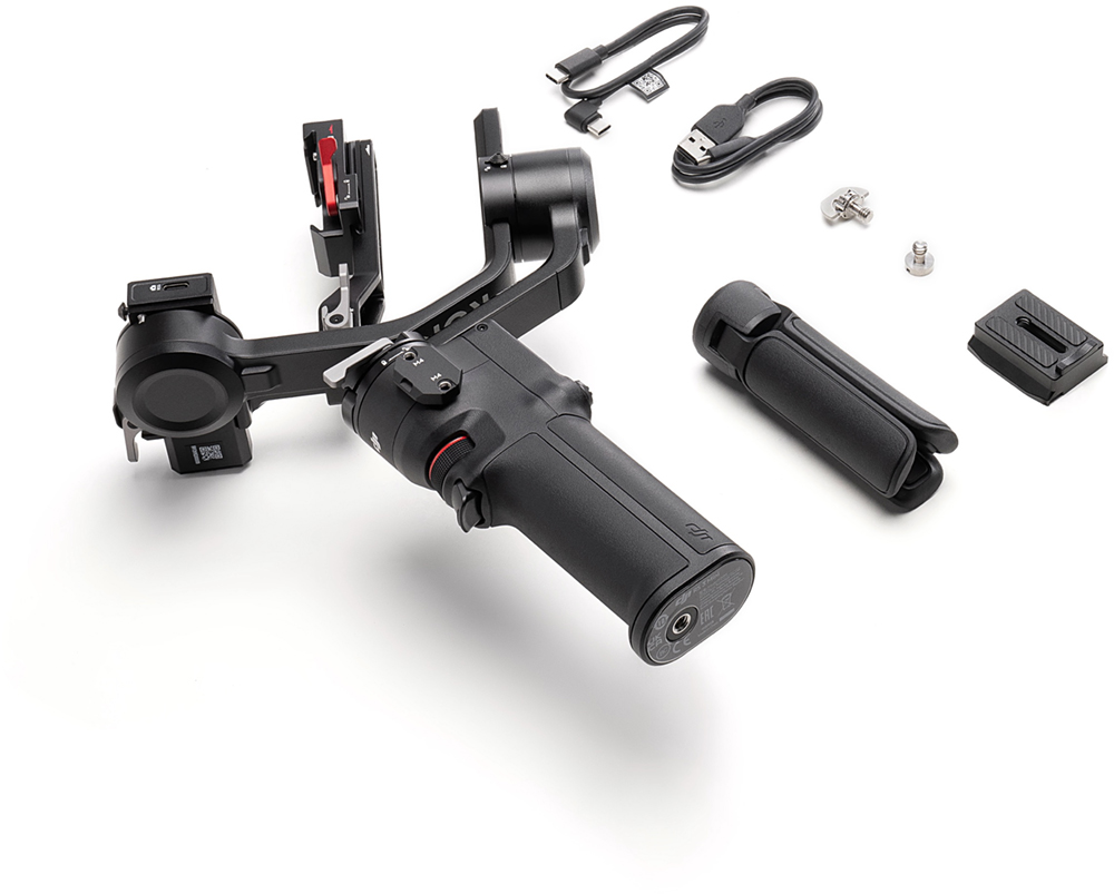 Stabilisateur de cardan noir avec accessoires : câbles, vis et petit trépied.