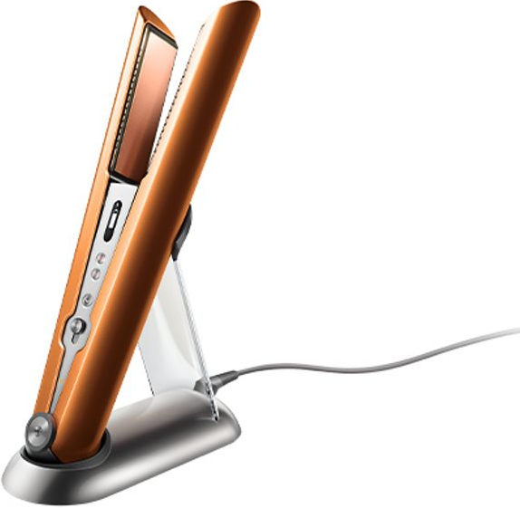 Lisseur de cheveux sur un support, corps orange, plaques de cuivre, cordon gris.