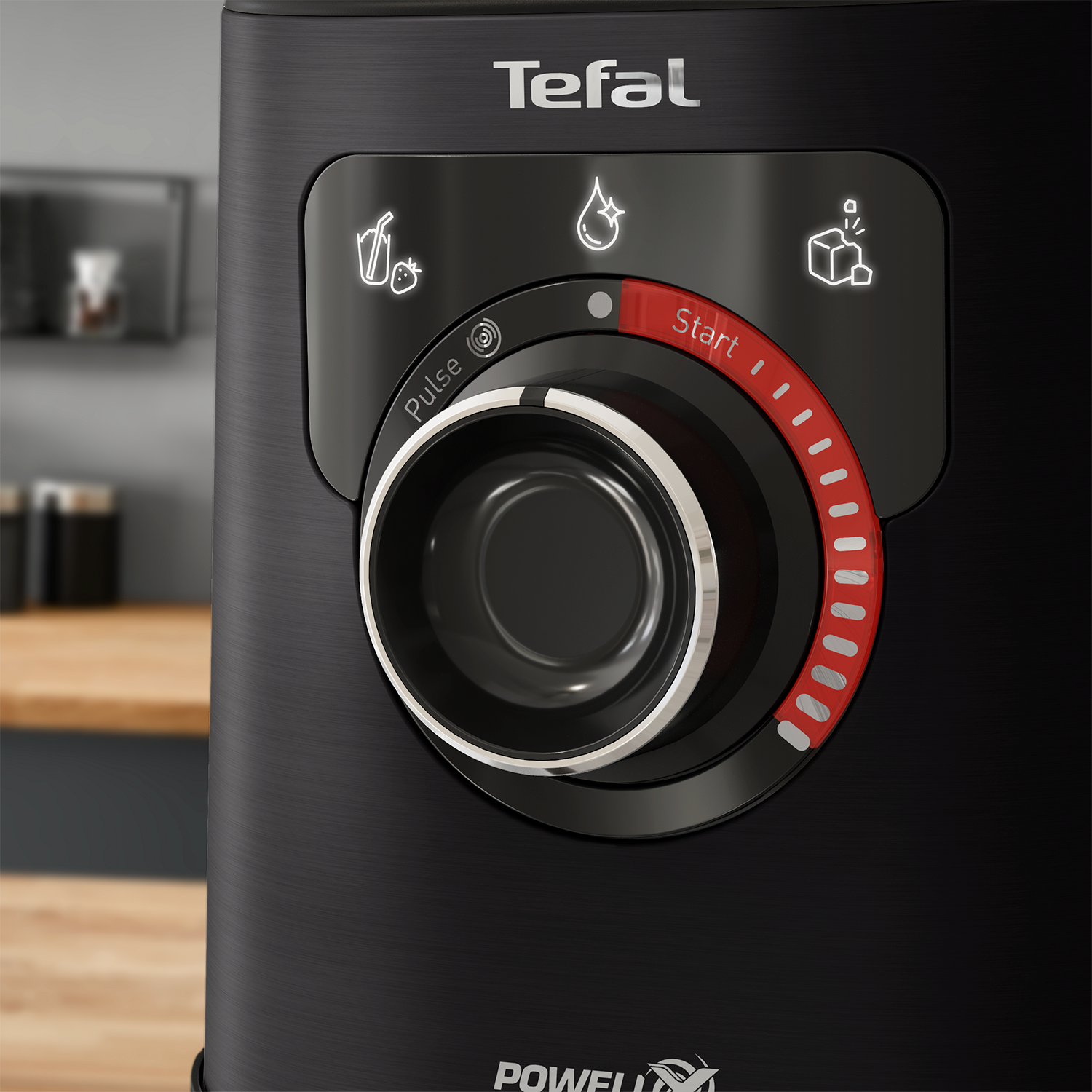 Close-up of a black Tefal air fryer control panel. It features a dial and buttons for various functions.