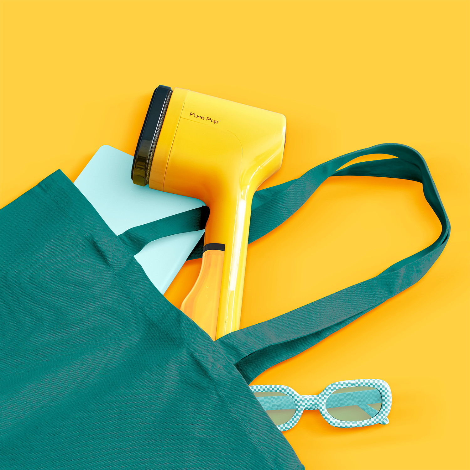 Teal bag with yellow hair dryer, light blue tablet, and checkered sunglasses on orange surface.