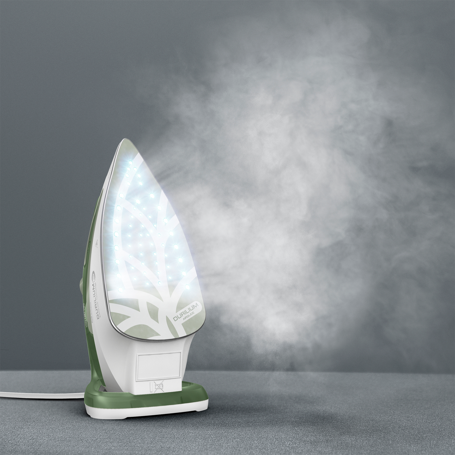 White and green iron with steam. Gray background, steam on right side.