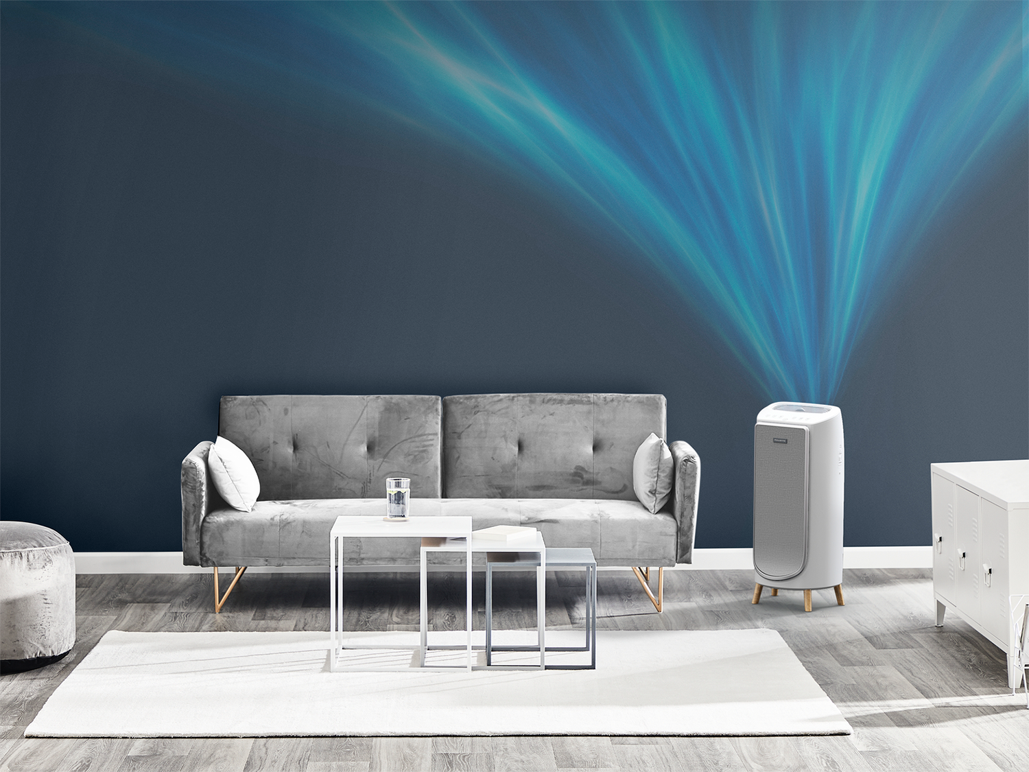 Living room with a grey sofa, white tables, and an air purifier emitting blue lights. Dark blue wall.