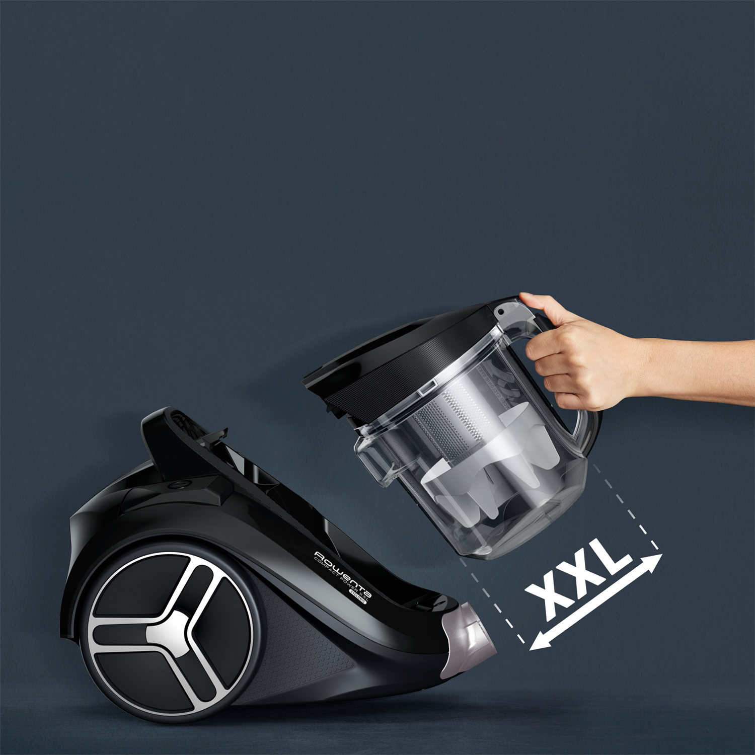 A black vacuum cleaner with an open compartment and a hand.