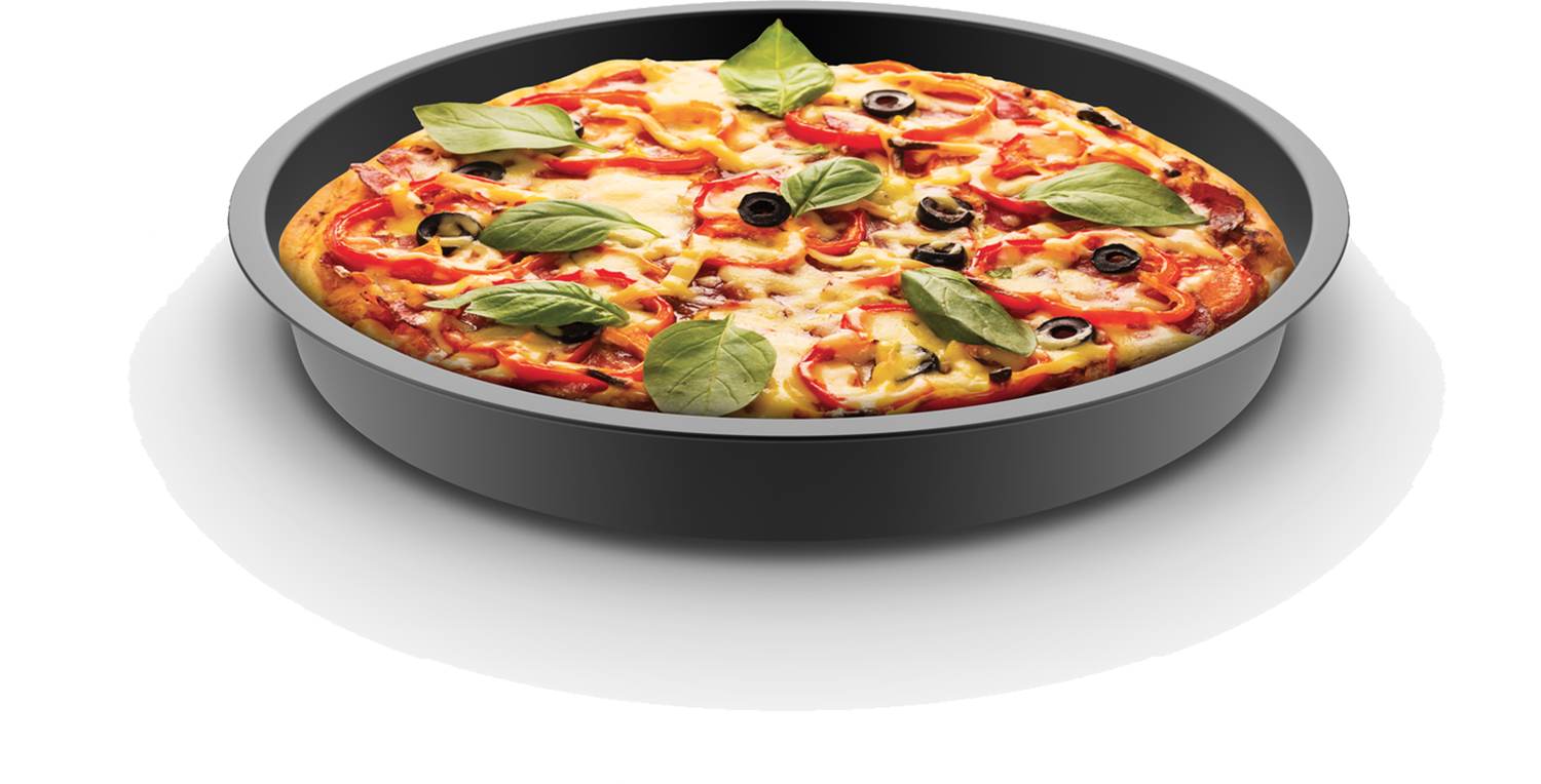 A round pizza in a dark pan, topped with basil, olives, and peppers.