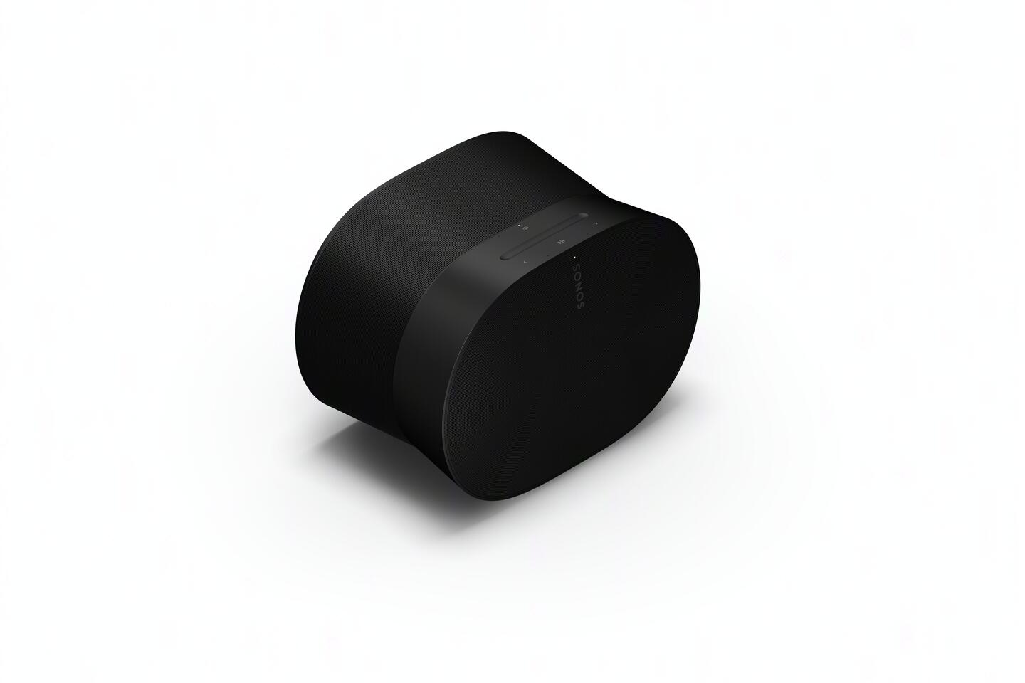 Altavoz negro de forma ovalada sobre un fondo blanco. El altavoz tiene una superficie sutil y texturizada.
