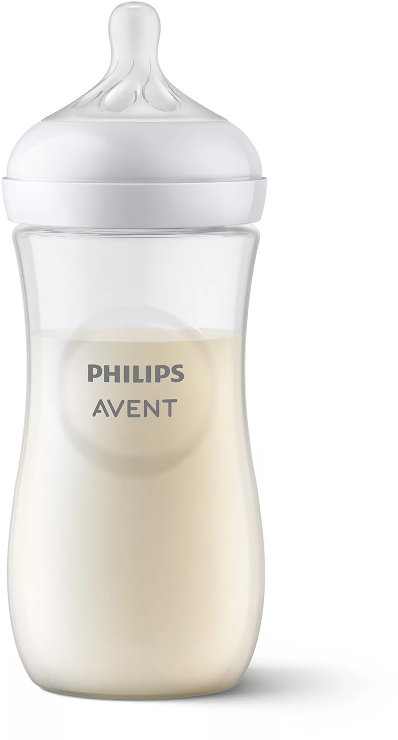 Átlátszó Philips Avent bébi cumisüveg tejjel, fehér kupakkal és mellbimbóval.