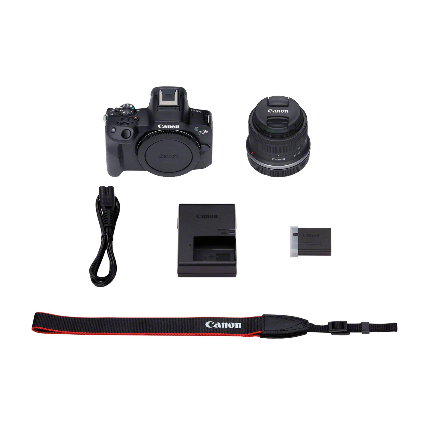 Fotocamera e accessori su una superficie bianca. Include un obiettivo, caricabatterie, batteria e cinturino.