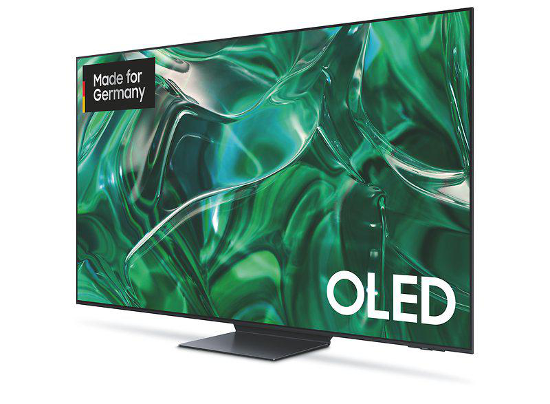 Ein Fernsehbildschirm, der ein grünes abstraktes Bild anzeigt. Der Fernseher ist mit OLED beschriftet, mit den Worten Made for Germany.