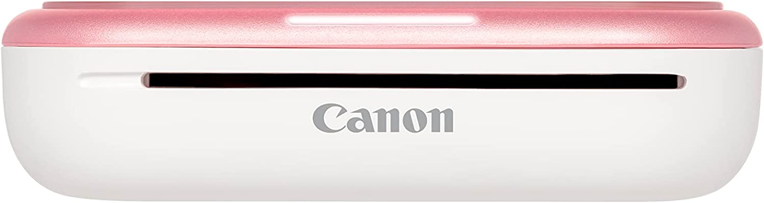 Una impresora fotográfica Canon Selphy Square blanca y rosa.