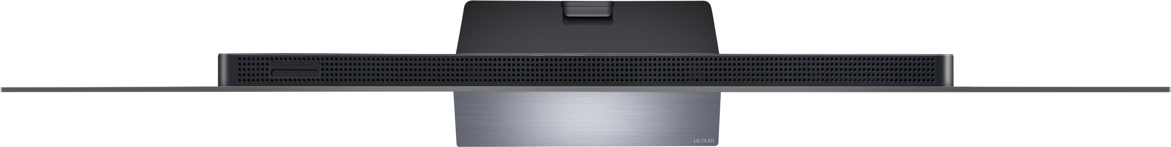 Draufsicht auf einen schwarzen Fernseher. Der Sockel ist silberfarben mit schwarzer Rückseite.