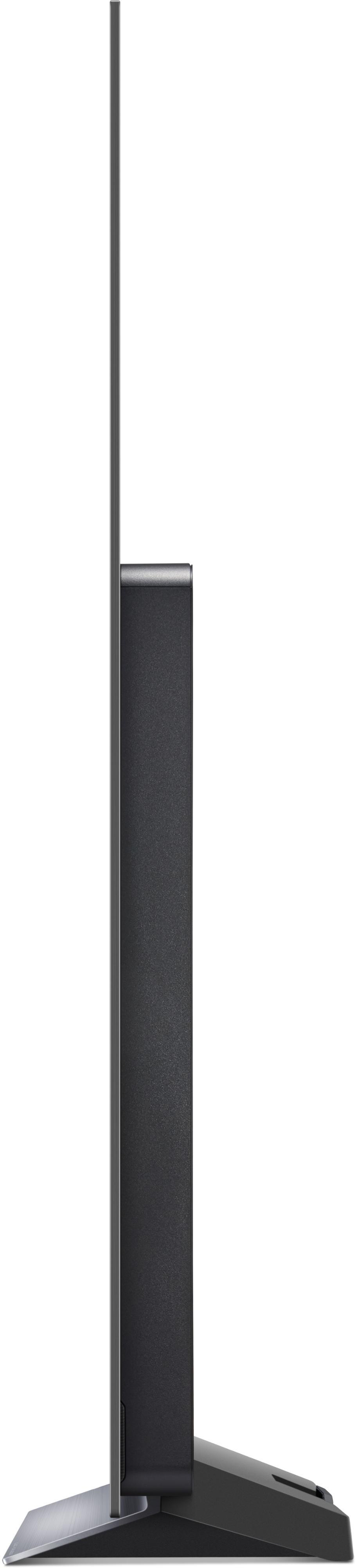 Seitenansicht eines schwarzen Fernsehers. Er steht auf einem Ständer.