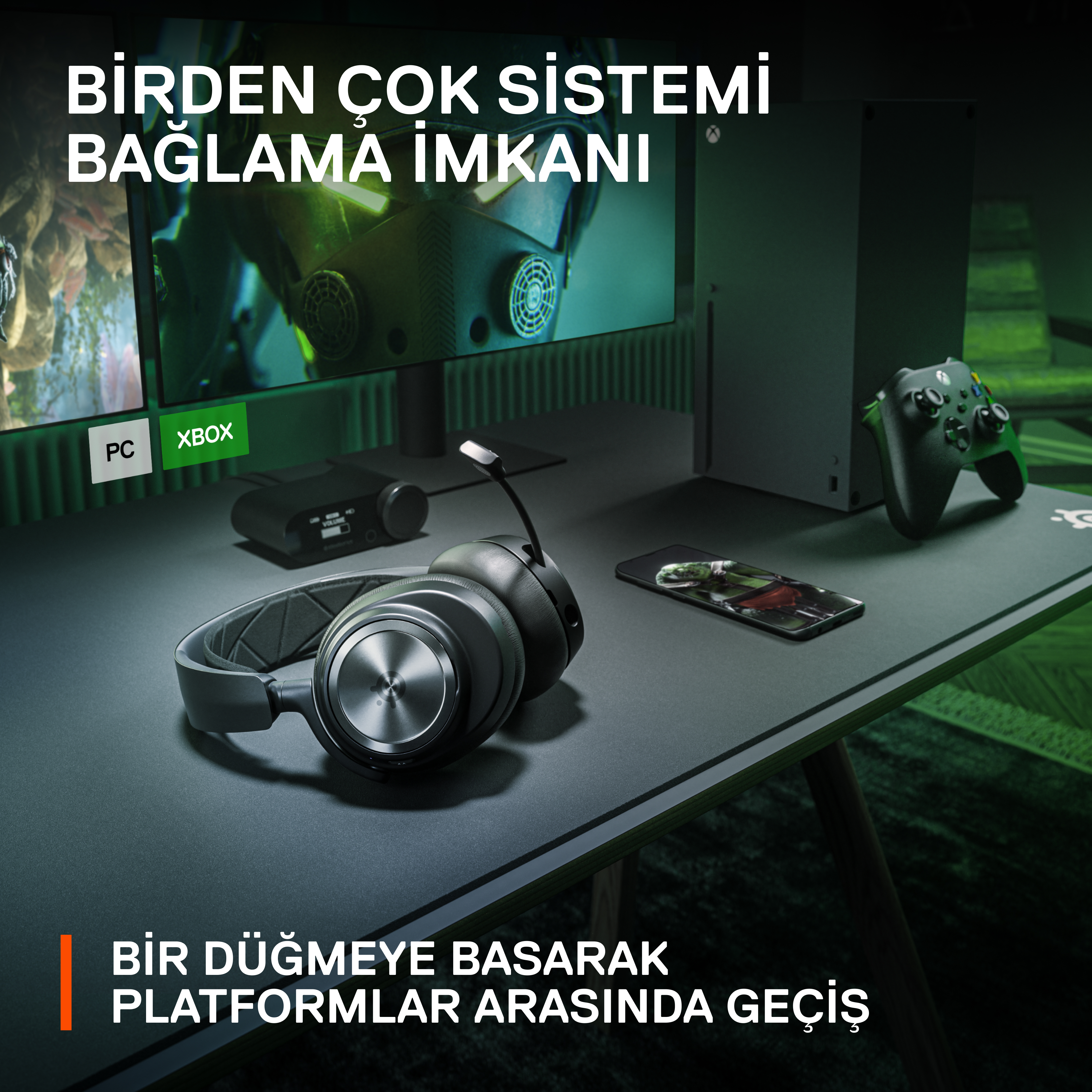 Monitör, Xbox ve PC etiketleri ve kulaklıklarla bir oyun kurulumu. Siyah masa.