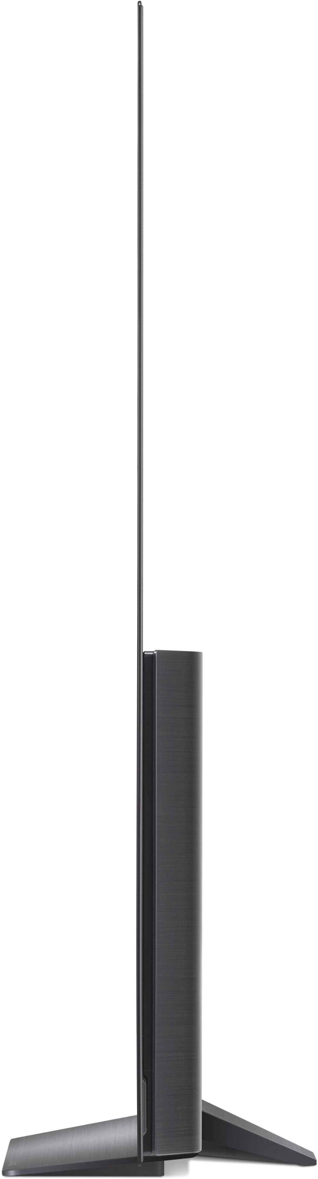 Seitenansicht eines sehr dünnen schwarzen Fernsehers auf einem Ständer. Der Bildschirm ist schwarz.