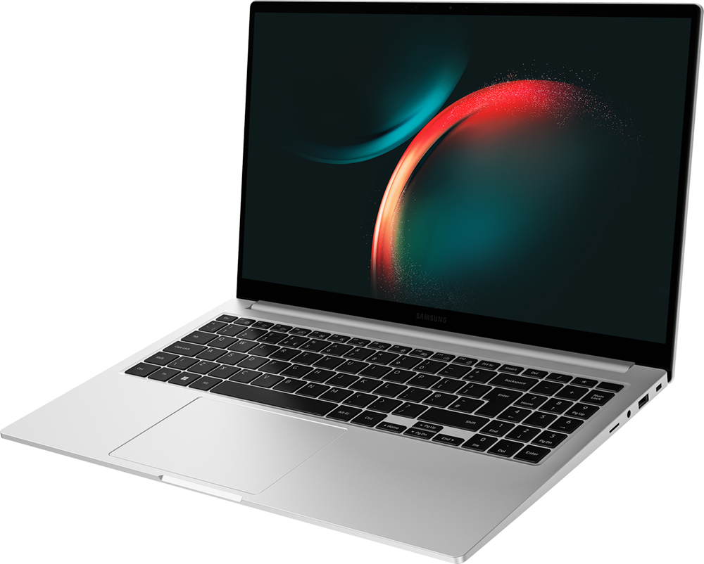 Ordinateur portable argenté avec clavier noir. L'écran affiche des couleurs abstraites. Logo Samsung sur la lunette. Ouvert sur surface blanche.