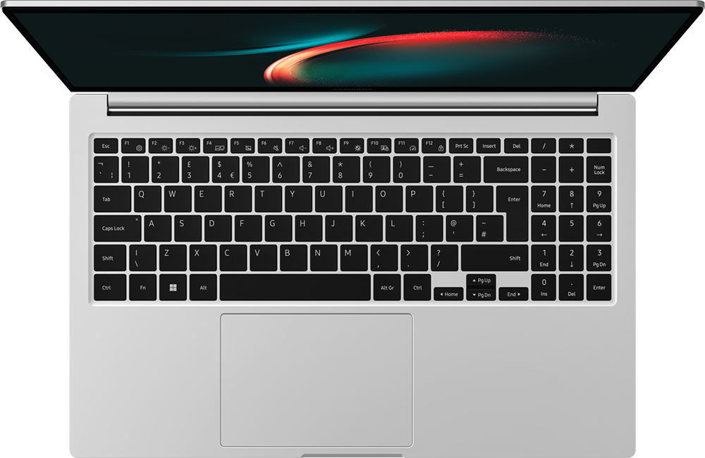 Vue de dessus d'un ordinateur portable argenté. L'écran est ouvert, affichant une image abstraite. Le clavier est noir.