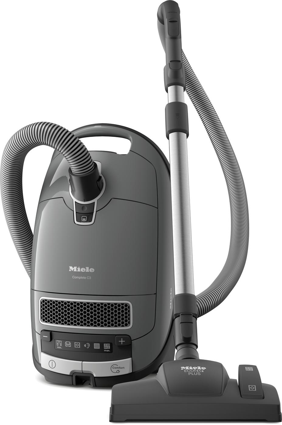 Ein grauer Miele Staubsauger. Er hat einen Hauptkörper, einen Schlauch und einen langen Griff mit Bürstenaufsatz.