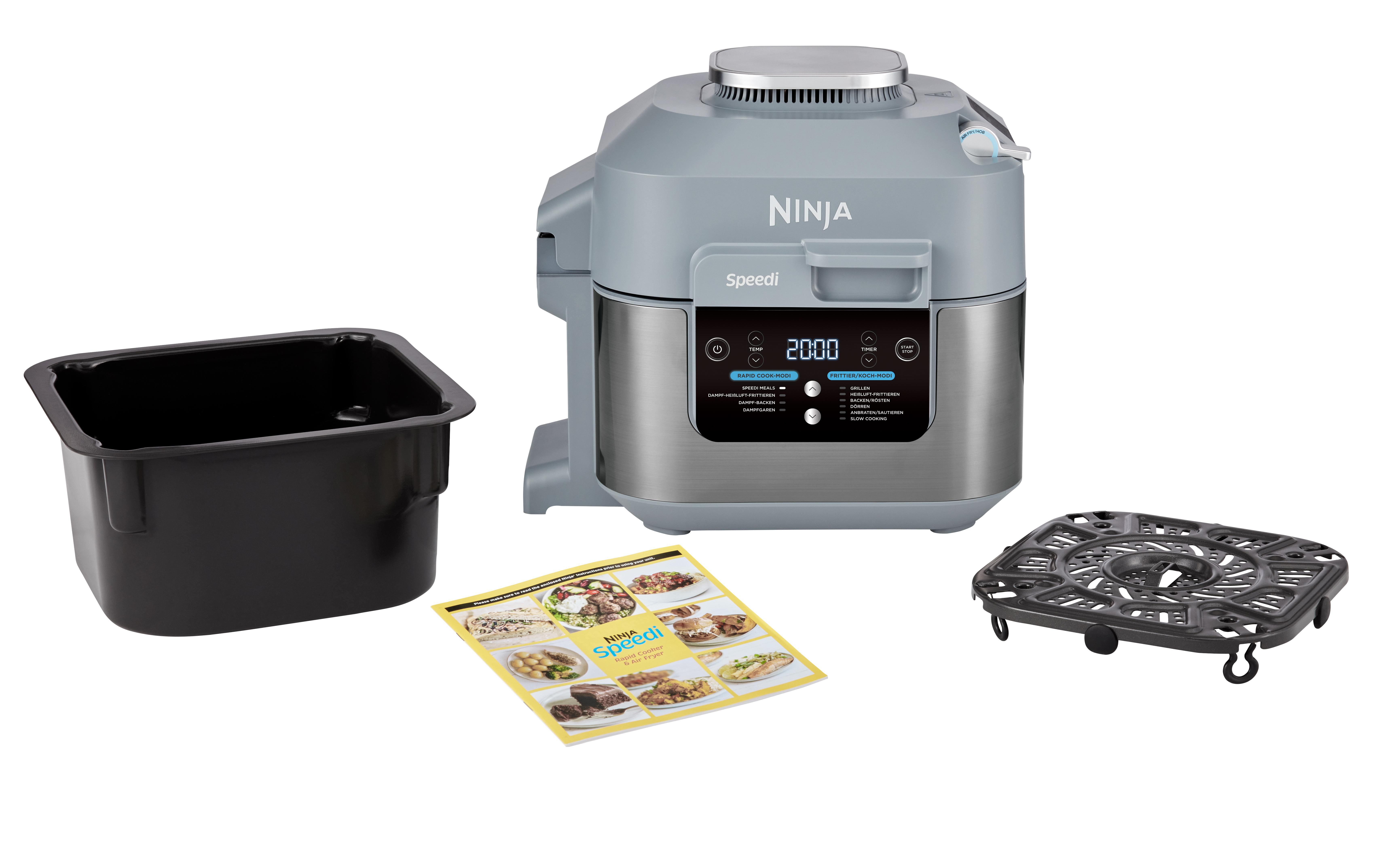 Ein Ninja Speedi Gerät mit Zubehör: eine schwarze Pfanne, ein Kochgestell und ein Rezeptheft.