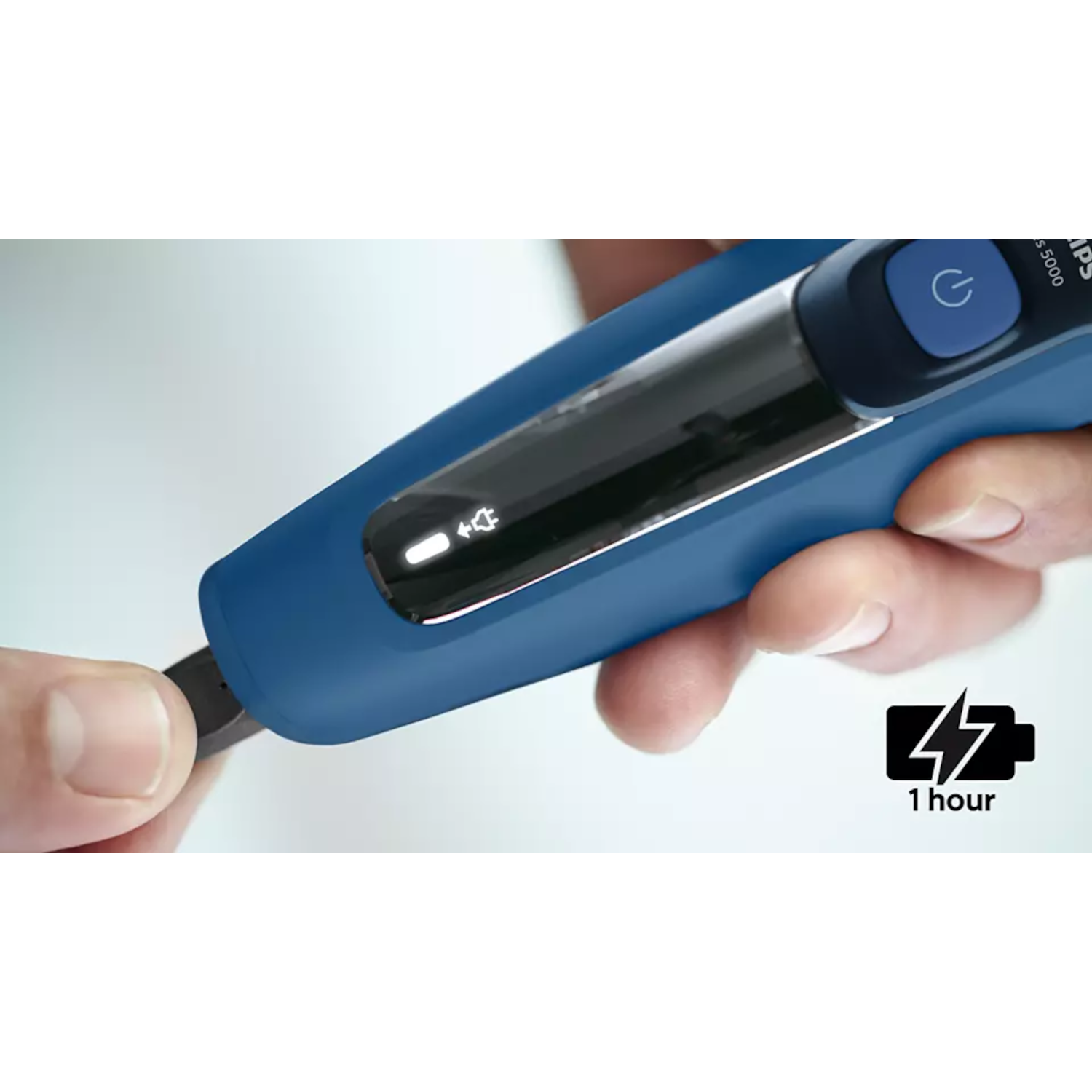 A blue and black electric shaver. A small battery icon is shown.