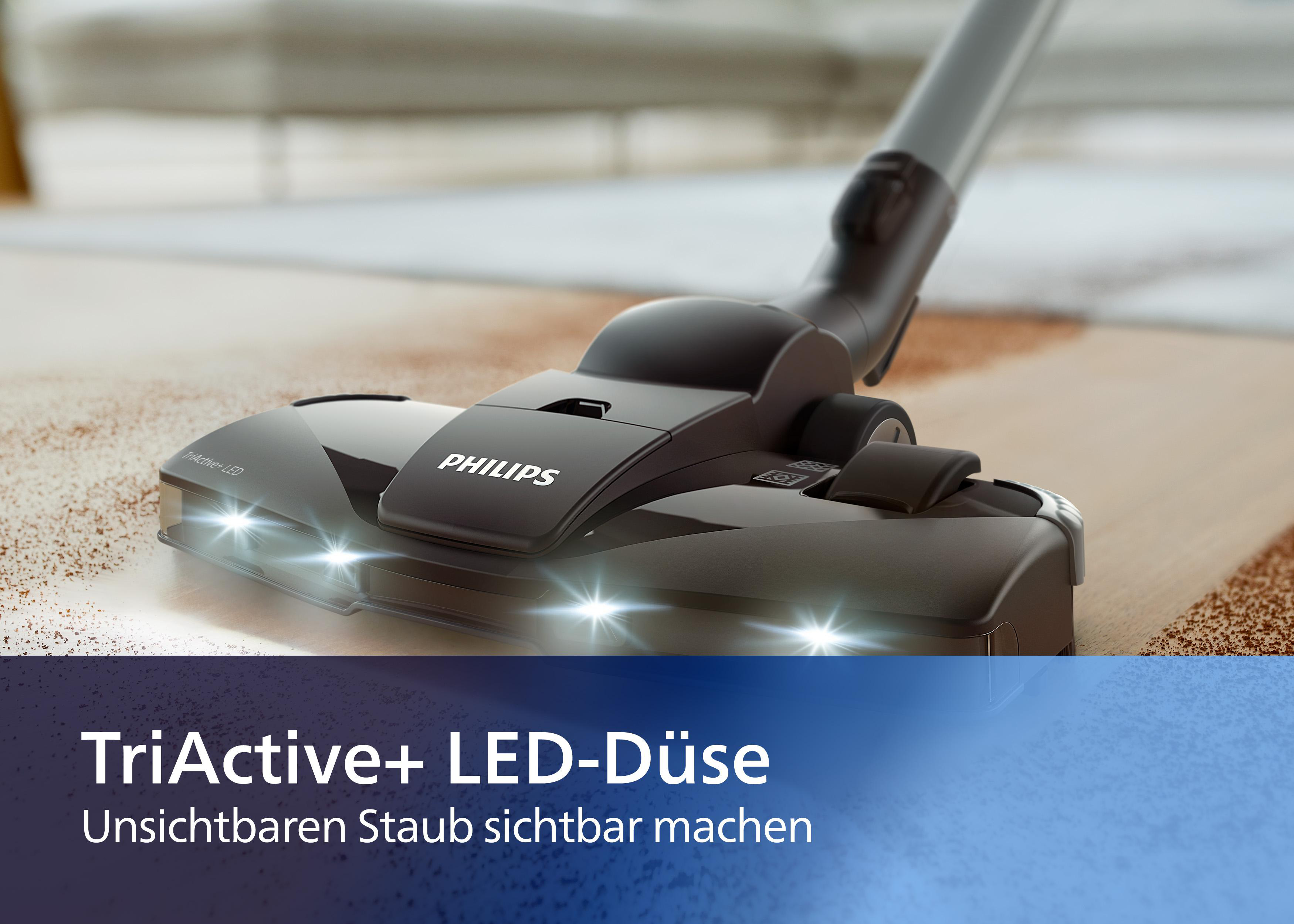 Ein Philips Staubsaugerkopf mit LED-Leuchten, auf einem Teppich, mit Textüberlagerung.