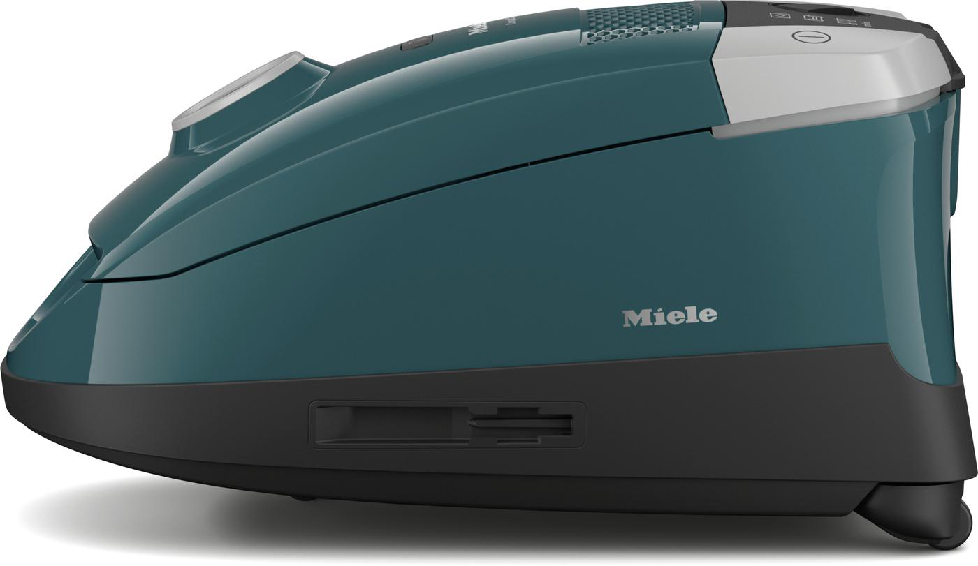 Türkisfarbener Staubsauger, Seitenansicht. Miele-Logo an der Seite, schwarze Akzente, weißer Hintergrund.