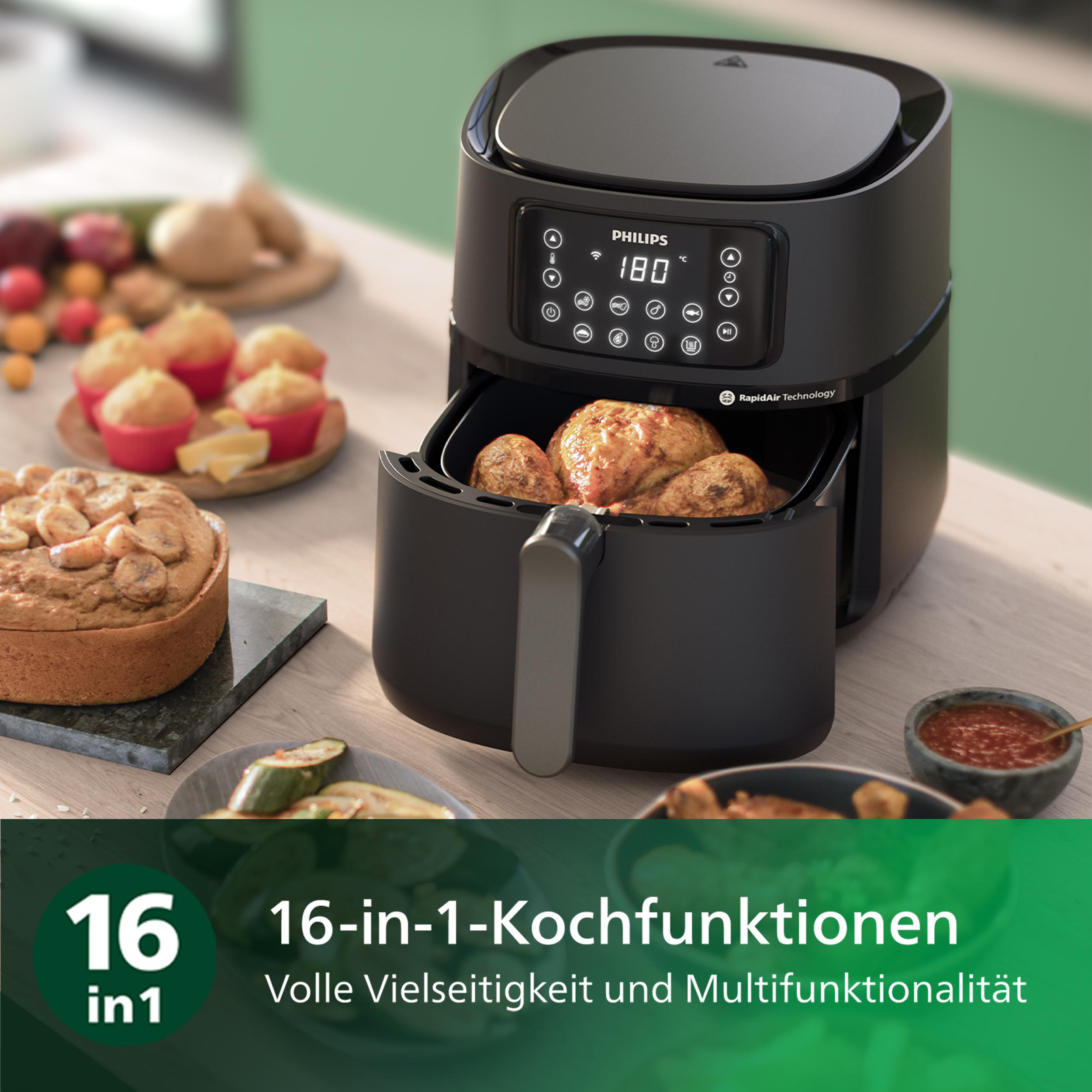 Eine Heißluftfritteuse mit Essen und anderen Lebensmitteln drumherum.