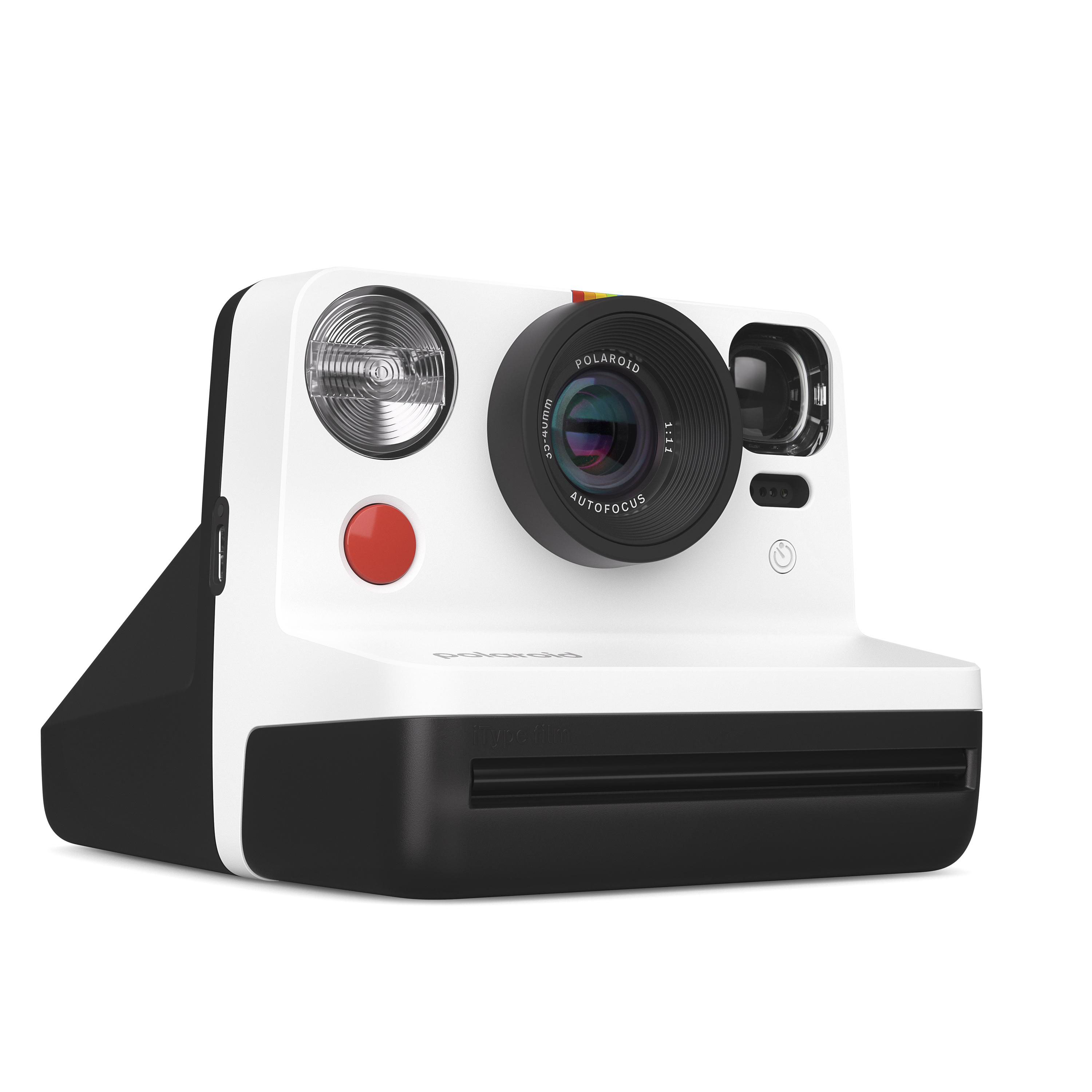 Weiße und schwarze Polaroid-Kamera mit rotem Knopf und Objektiv.