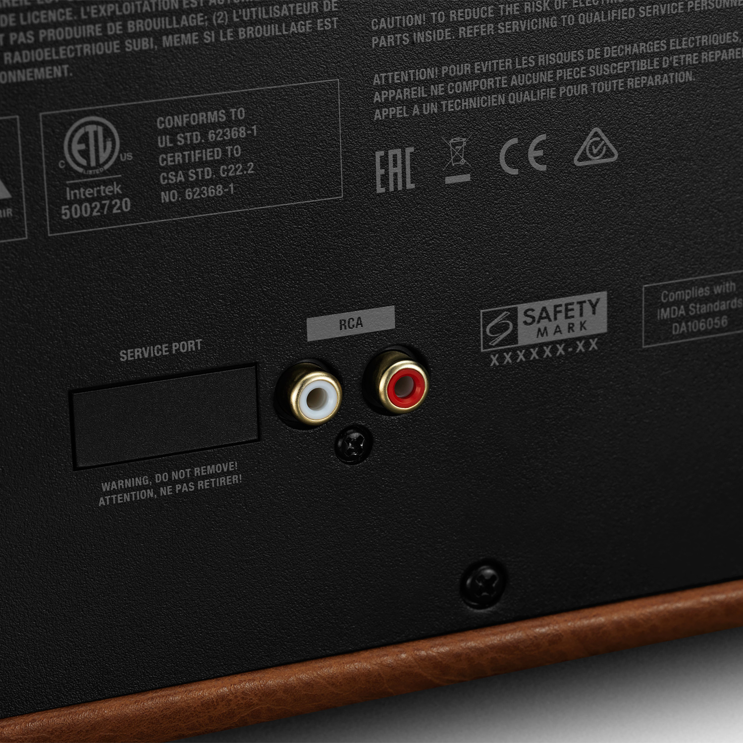Arrière d'un appareil avec ports RCA et de service, ainsi que la marque et les certifications. Marron et noir.
