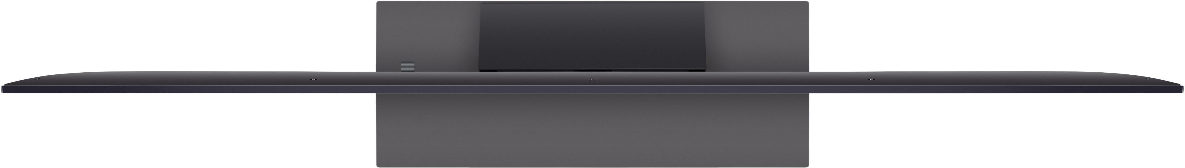 Fernseher von oben, grau, breit. Schwarzer Rahmen, dunkelgraue Rückseite.