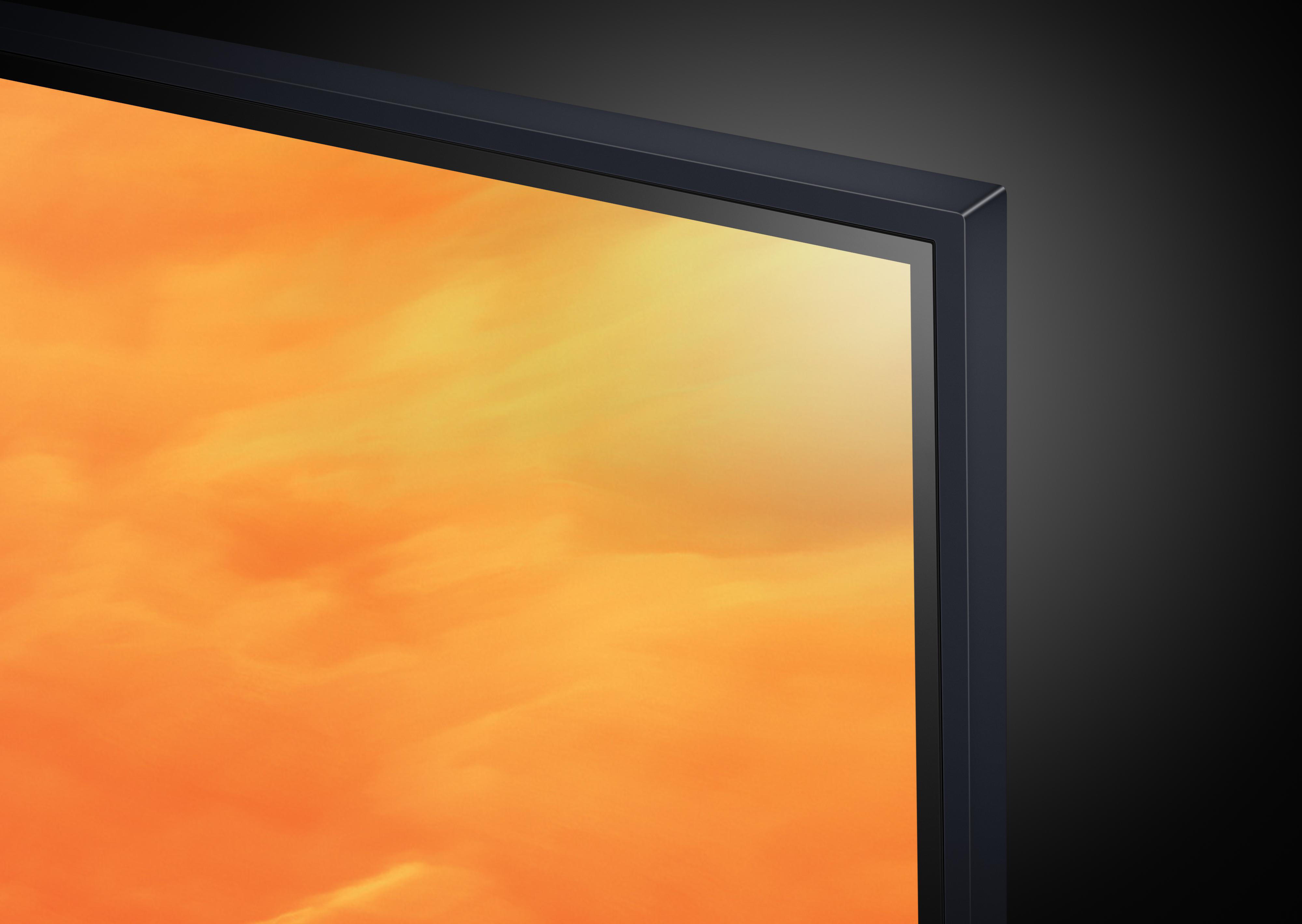 Eckansicht eines schwarzen Fernsehbildschirms mit warmem orangefarbenem Hintergrund.
