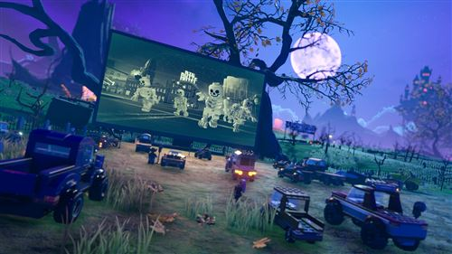 Escena de Halloween de Lego: una pantalla muestra esqueletos. Coches Lego en un campo de noche.