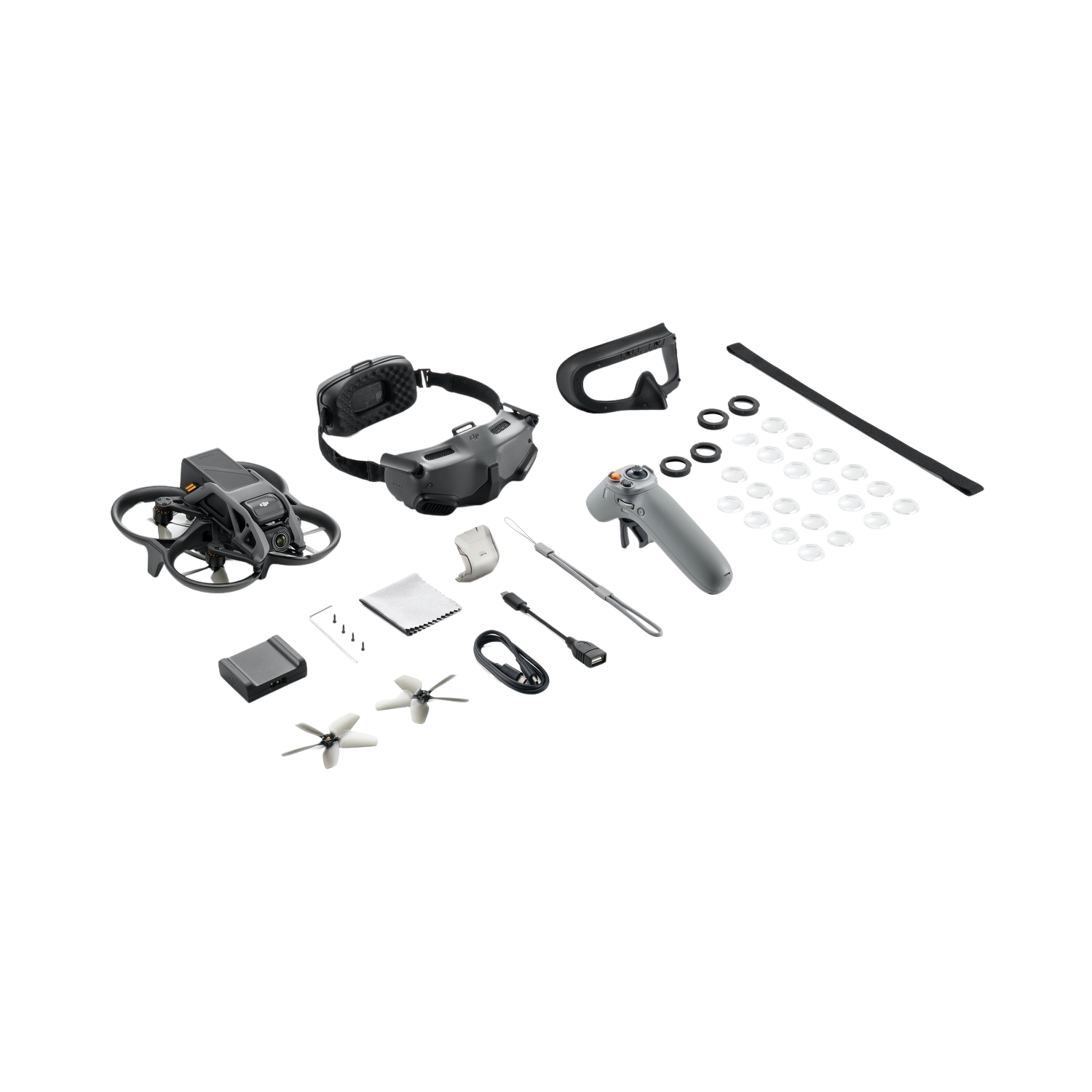 A drone kit with a drone, goggles, remote, propellers, and accessories on a black background.