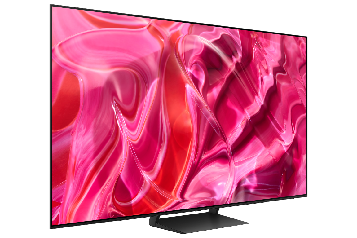 Büyük bir TV, siyah bir arka plan üzerinde pembe ve kırmızı soyut bir görüntü görüntüler.