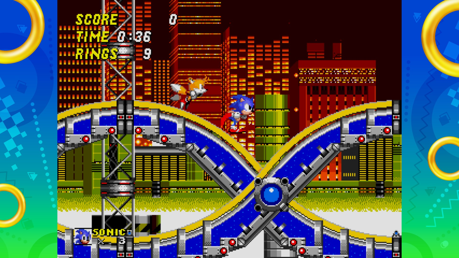 Sonic e Tails corrono su un anello in un gioco di Sonic. Grattacieli e struttura blu sullo sfondo.