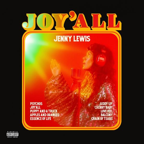Albumcover. Jenny Lewis singt in ein Mikrofon, rot/gelber Hintergrund, Text: JOY'ALL.