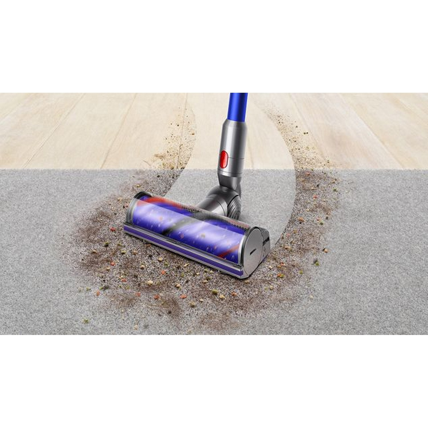 Vacuum cleaner head cleaning a gray carpet. Dirt is visible around the cleaning area.