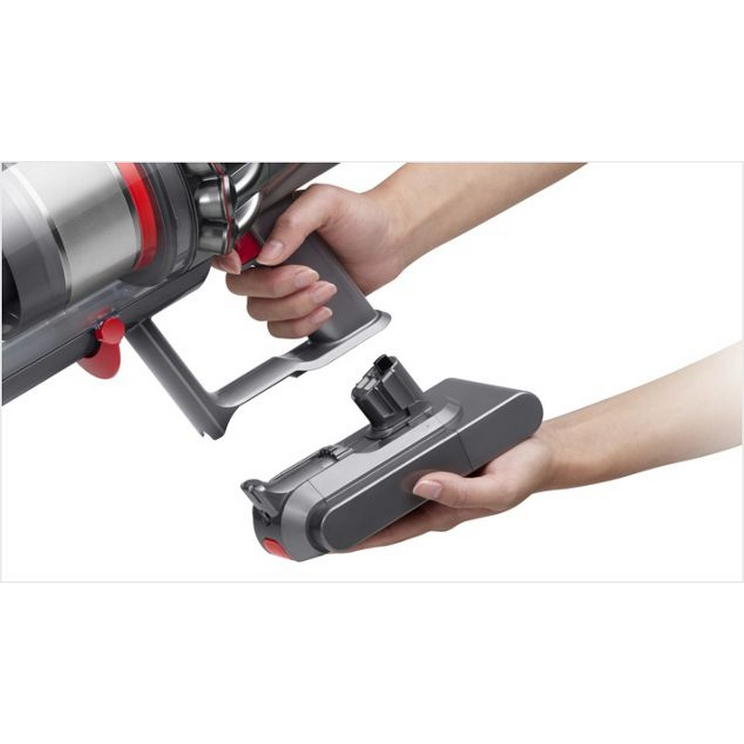 Two hands holding a vacuum cleaner component. The component is gray and detached from the main body.