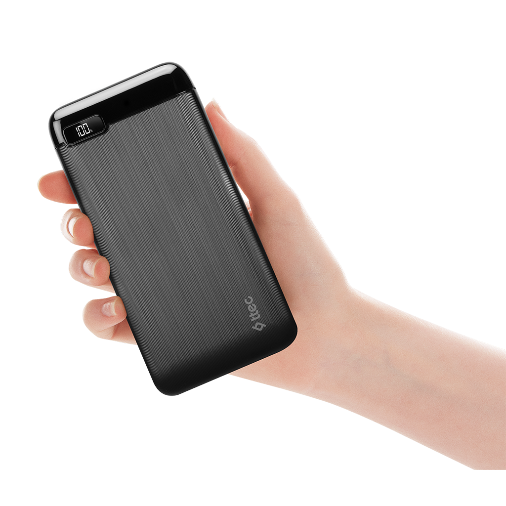 El, %100 şarj gösteren dijital ekranlı siyah bir powerbank tutuyor.