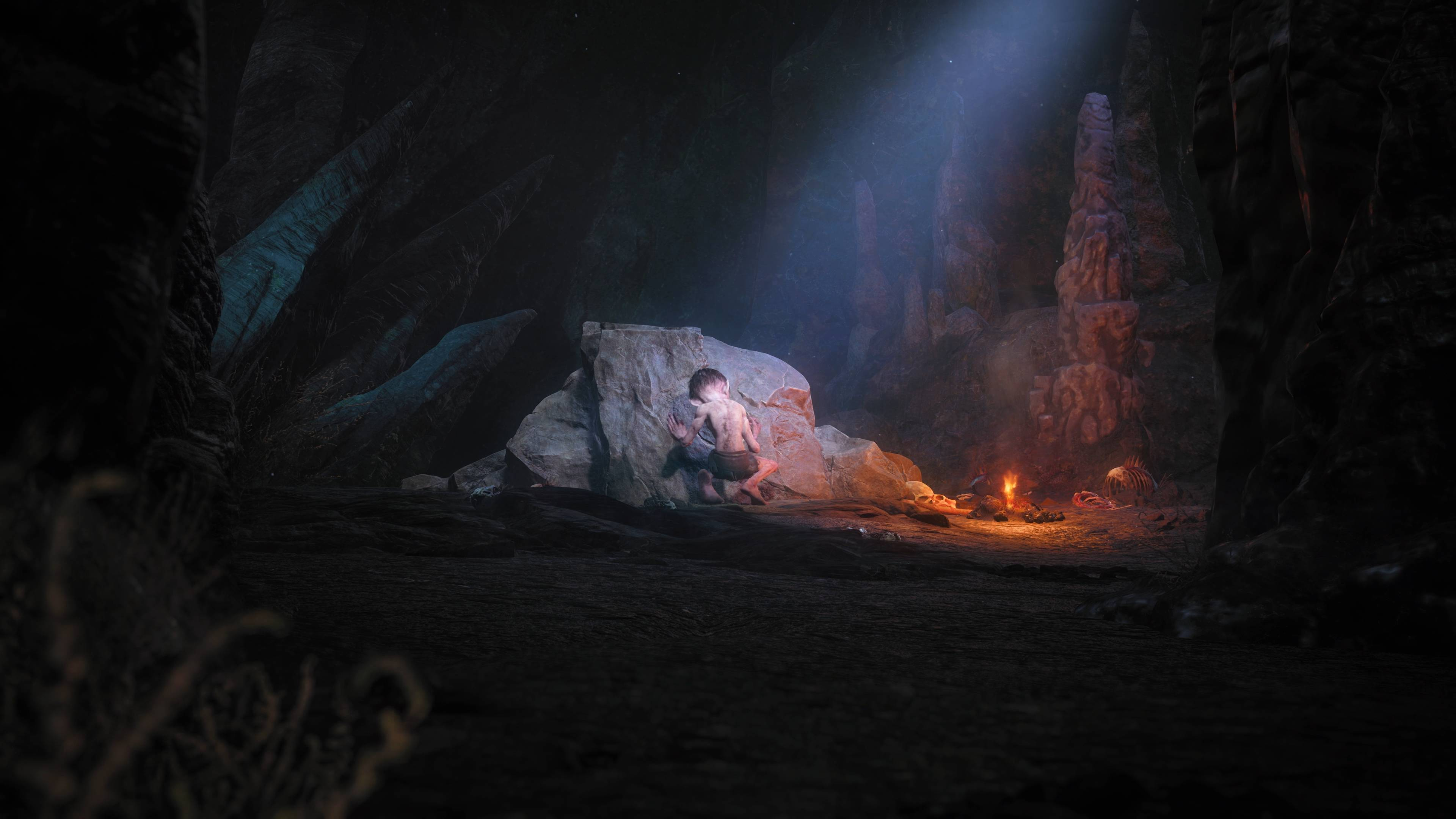 Höhlenszene mit Junge am Feuer, Felsformationen und schwachem Licht.