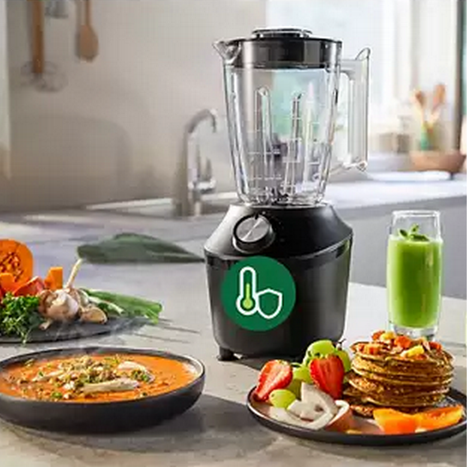 Blender with ingredients, a glass of smoothie and pancakes.