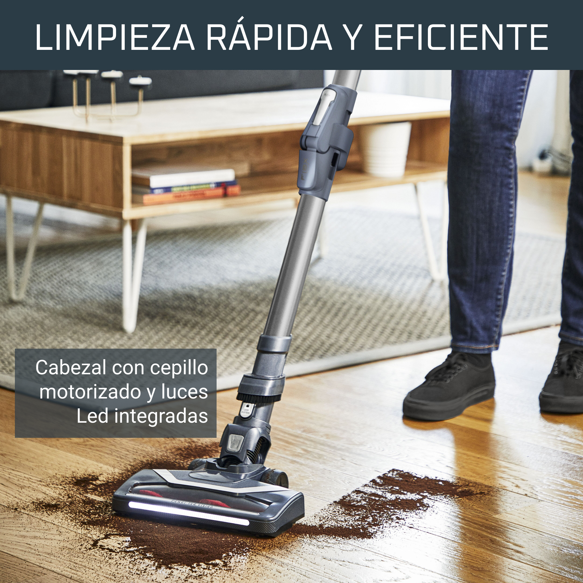 Una persona aspira un piso de madera con una aspiradora. Hay suciedad en el suelo.