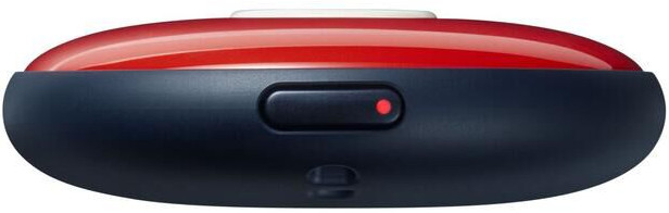Een close-up van een apparaat met een rode knop en een klein rood lampje. Het apparaat is donkerblauw.